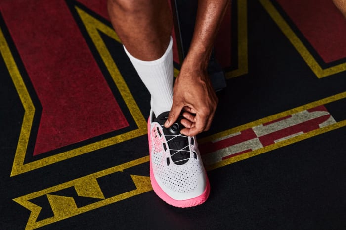 View of white and pink Under Armour shoe.